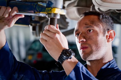 Mechanic fixing a car at the garage