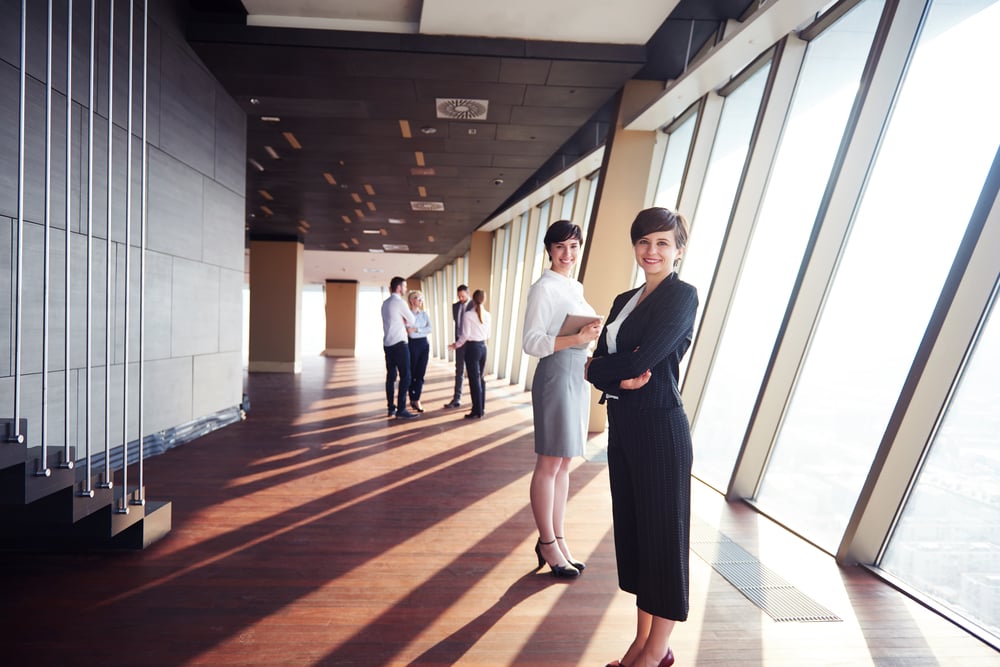 business people group, females as team leaders standing together in modern bright office interior